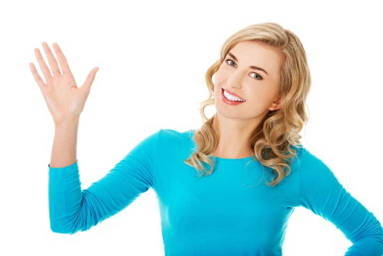 Portrait of a woman waving to the camera.